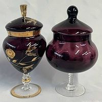 Both lidded amethyst candy bowls side by side showing design differences