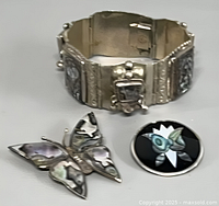 Bracelet and two brooches overall view