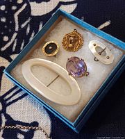 All five jewelry pieces arranged in box