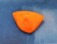 Front view of triangular amber brooch