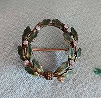 Front view of wreath brooch showing enamel oak leaves, diamonds and acorn