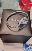 Watch displayed on Georg Jensen box showing open bangle design