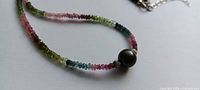 Close-up of tourmaline beads and pearl focal