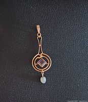 Front view of 10k gold pendant showing design and stones