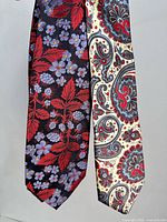 Full view of two silk ties hanging side by side