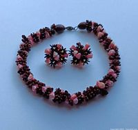 Necklace arranged in circle with earrings centred