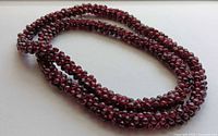 Full view of coiled garnet bead necklace