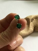 Front view of both earrings showing green stones and prong settings