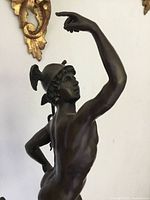 Upper torso of bronze Mercury with raised arm and winged helmet