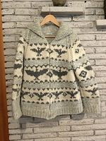 Front view of Cowichan wool sweater on hanger