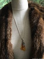 Necklace displayed on mannequin with fur collar