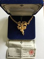 Necklace in open blue velvet box with certificate displayed