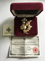 Brooch in presentation box with certificate and Camrose & Kross card visible