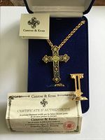 Full set inside open blue velvet box: cross necklace, chain, stand, certificate visible