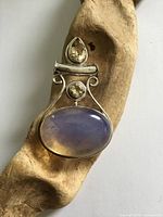 front view showing moonstone cabochon and crystal stones in silver frame