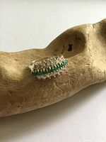 Oblique view of ring showing emerald and crystal rows