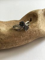 Front view showing two round mystic topaz stones and band