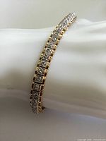 Bracelet curved around display wrist showing gilt and diamond setting