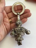 Full view showing rattle, whistle end, silver bells, MOP handle