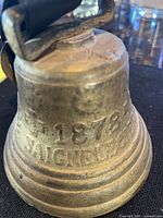 Side view showing 1878 Saignelegier inscription on brass bell