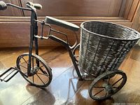 Full view of decorative wood and metal tricycle with wicker basket