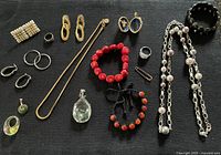 Group shot of all jewelry pieces spread on black fabric