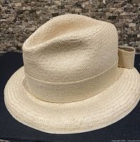Full side view of straw Panama hat with grosgrain band and bow