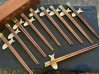 Full set of chopsticks and rests laid out beside box