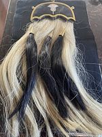 Front view showing full length horsehair and brass frame