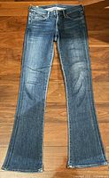 Front view of blue denim slim boot jeans