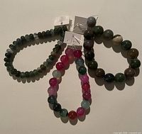 Three agate bead strands laid flat