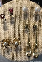 all five pairs of earrings on display pad