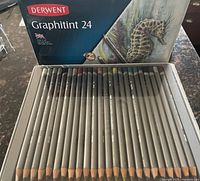 Open tin showing full set of 24 Derwent Graphitint pencils