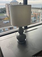Full view of lamp with shade on tabletop