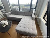 Full view of grey L-shaped sectional in room