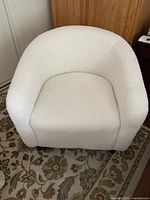 Front view of cream boucle tub chair