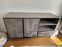 Front view of media console showing doors, shelves and drawer