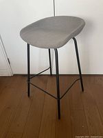 Full view of stool front angle showing seat and legs