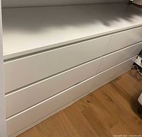 Front view showing six drawers and white finish