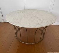 Full view of coffee table showing marble top and metal cage base