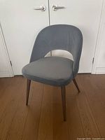 Front angled view of blue velvet dining chair showing overall design and condition