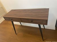 Full view of console table front angle showing drawers and legs