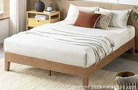 Staged view of walnut platform bed with mattress showing overall style