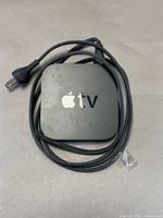 Top view of Apple TV with cable wrapped around