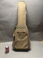 Taylor tan gig bag front view with Coca-Cola can for scale