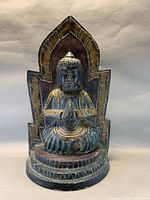 Full frontal view of carved wood Buddha statue