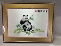 Full view of framed embroidered panda picture