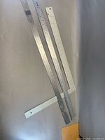 Framing square and two rulers full view