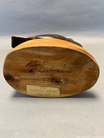 Underside showing signature Robert Derbyshire, number, and April 1989 inaugural meeting label