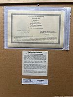 Certificate of authenticity showing title, artist, edition number, date